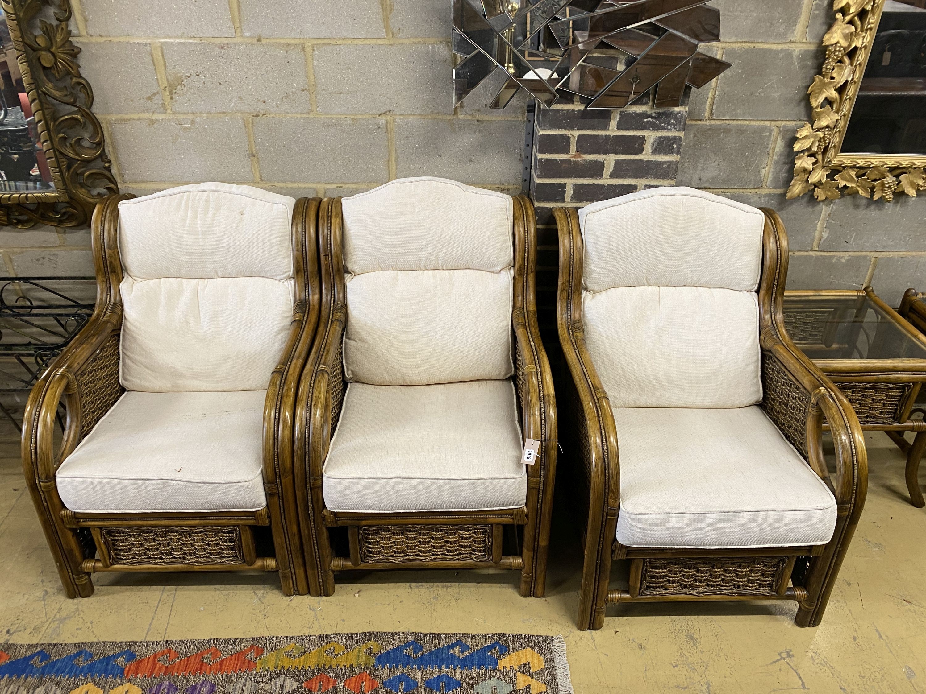 A caned bamboo six piece conservatory suite comprising four armchairs with loose cushions, width 68cm, depth 90cm, height 93cm and two side tables